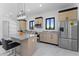 Bright kitchen featuring an island with marble countertop and stainless steel appliances at 12560 E Cochise Dr, Scottsdale, AZ 85259