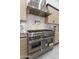 Kitchen featuring stainless steel stove and stainless steel vent hood at 12560 E Cochise Dr, Scottsdale, AZ 85259