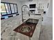 Kitchen island featuring stainless steel sink and built in accessories with Gathering room views at 12560 E Cochise Dr, Scottsdale, AZ 85259