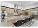 Spacious kitchen featuring an island with a marble countertop and bar stool seating at 12560 E Cochise Dr, Scottsdale, AZ 85259