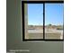 A bright window view of desert landscaping with cacti, trees, and paved road at 12560 E Cochise Dr, Scottsdale, AZ 85259