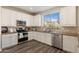 Modern kitchen features stainless steel appliances and granite countertops at 1278 E Geona Ct, San Tan Valley, AZ 85140