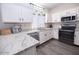 Modern kitchen with white cabinets and granite countertops at 1425 S Lindsay Rd # 20, Mesa, AZ 85204