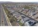 An aerial view showcasing a community with well-maintained lawns and houses with solar panels at 14369 W Wethersfield Rd, Surprise, AZ 85379