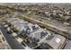 An aerial view displays homes with solar panels on roofs within a lovely, developed community at 14369 W Wethersfield Rd, Surprise, AZ 85379