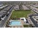 Aerial view of neighborhood featuring large green space and community pool at 14369 W Wethersfield Rd, Surprise, AZ 85379