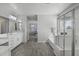 Bright bathroom featuring dual sinks, wood-look tile flooring, and a separate tub and shower at 14369 W Wethersfield Rd, Surprise, AZ 85379