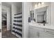 Bathroom with white cabinets, a large mirror, and a shower with a striped curtain at 14369 W Wethersfield Rd, Surprise, AZ 85379