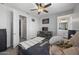 This bedroom has great natural light, neutral walls, and a sleek dresser with a television at 14369 W Wethersfield Rd, Surprise, AZ 85379