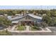 Exterior building shot of clubhouse featuring wood beam details and landscaped entry at 14369 W Wethersfield Rd, Surprise, AZ 85379