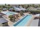 This aerial shot reveals the expansive community pool area, complete with seating, shade, and a Gathering pool at 14369 W Wethersfield Rd, Surprise, AZ 85379