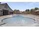 A view of the community pool features a unique shape and offers a Gathering-friendly environment at 14369 W Wethersfield Rd, Surprise, AZ 85379