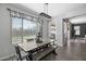 Well-lit dining area featuring modern light fixture and view of the backyard at 14369 W Wethersfield Rd, Surprise, AZ 85379