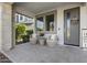 Cozy front porch featuring stylish outdoor seating, decorative accents, and a welcoming entrance at 14369 W Wethersfield Rd, Surprise, AZ 85379