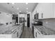 Contemporary kitchen with a center island, sleek stainless steel appliances, and ample counter space at 14369 W Wethersfield Rd, Surprise, AZ 85379