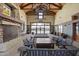 Interior view of lobby with fireplace, wood beam ceiling, and outdoor access at 14369 W Wethersfield Rd, Surprise, AZ 85379