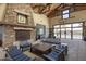 Interior view of lobby with fireplace, wood beam ceiling, and outdoor access at 14369 W Wethersfield Rd, Surprise, AZ 85379