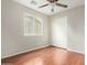 Neutral bedroom with hardwood floors, ceiling fan, window, and closet at 15118 W Lincoln St St, Goodyear, AZ 85338