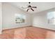 Large bedroom with wood floors, two large windows, and ceiling fan at 15118 W Lincoln St St, Goodyear, AZ 85338