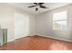 Neutral bedroom with hardwood floors, ceiling fan, window, and closet at 15118 W Lincoln St St, Goodyear, AZ 85338