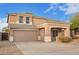 Two-story home featuring a two-car garage, covered porch, and neutral-toned stucco exterior at 15118 W Lincoln St St, Goodyear, AZ 85338