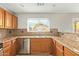 Kitchen featuring stainless appliances, light wood cabinets, and a decorative tile backsplash at 15118 W Lincoln St St, Goodyear, AZ 85338