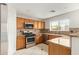 Well-lit kitchen with stainless steel oven and microwave, complimented by tile backsplash and granite countertop at 15118 W Lincoln St St, Goodyear, AZ 85338