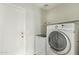 Bright laundry room features modern washer and dryer units, plus convenient shelving for storage at 15118 W Lincoln St St, Goodyear, AZ 85338