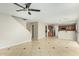 Bright, open-concept living space with tile flooring flowing into the adjacent kitchen area at 15118 W Lincoln St St, Goodyear, AZ 85338