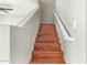 A view of the home's wooden staircase, featuring a classic white handrail and gray walls at 15118 W Lincoln St St, Goodyear, AZ 85338