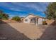 Backyard view of house, gravel, and patio at 15145 W Elko Dr, Surprise, AZ 85374