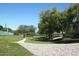 Scenic view of a green space with walking path and mature trees at 15145 W Elko Dr, Surprise, AZ 85374