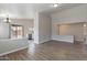 Bright living room with wood-look tile floors and an open floor plan at 15145 W Elko Dr, Surprise, AZ 85374