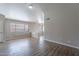 Bright living room with wood-look tile floors and an open floor plan at 15145 W Elko Dr, Surprise, AZ 85374