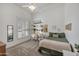 Bright bedroom featuring white walls, shuttered windows, and a built-in shelving unit at 1560 W Augusta Ave, Phoenix, AZ 85021