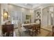 Traditional dining room with a wooden table, upholstered chairs, shuttered windows, and elegant decor at 1560 W Augusta Ave, Phoenix, AZ 85021