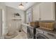 Well-organized laundry room with modern washer and dryer, built-in cabinets, sink, and ample storage at 1560 W Augusta Ave, Phoenix, AZ 85021