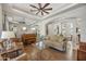 Comfortable living room featuring hardwood floors, modern ceiling fan, and ample natural light at 1560 W Augusta Ave, Phoenix, AZ 85021