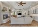 Bright living area with hardwood floors, fireplace, ceiling fans, and built in shelving at 1560 W Augusta Ave, Phoenix, AZ 85021