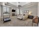 Spacious main bedroom with a fireplace, a ceiling fan, plantation shutters, and neutral décor at 1560 W Augusta Ave, Phoenix, AZ 85021