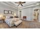 Comfortable main bedroom features tray ceilings, carpet flooring, and a charming antique desk at 1560 W Augusta Ave, Phoenix, AZ 85021