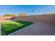 Artificial turf backyard with block wall and string lights at 1631 E Paul Dr, Casa Grande, AZ 85122