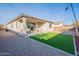 Artificial turf backyard with covered patio and string lights at 1631 E Paul Dr, Casa Grande, AZ 85122