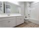 Bathroom with white vanity, tub, and tile floor at 1631 E Paul Dr, Casa Grande, AZ 85122