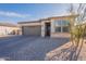 Single-story home with a two-car garage and desert landscaping at 1631 E Paul Dr, Casa Grande, AZ 85122