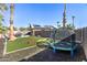 Spacious backyard featuring artificial grass, a trampoline, grill and play area at 16934 N 158Th Ave, Surprise, AZ 85374