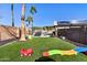 Spacious backyard featuring artificial grass, a grill, and a play area at 16934 N 158Th Ave, Surprise, AZ 85374