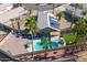 Aerial view of a private backyard featuring a pool, patio and artificial turf at 16934 N 158Th Ave, Surprise, AZ 85374