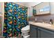 Quirky bathroom featuring unique dinosaur-themed shower curtain and patterned vanity at 16934 N 158Th Ave, Surprise, AZ 85374