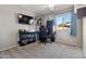 A bright bedroom with a large window and a gaming setup at 16934 N 158Th Ave, Surprise, AZ 85374